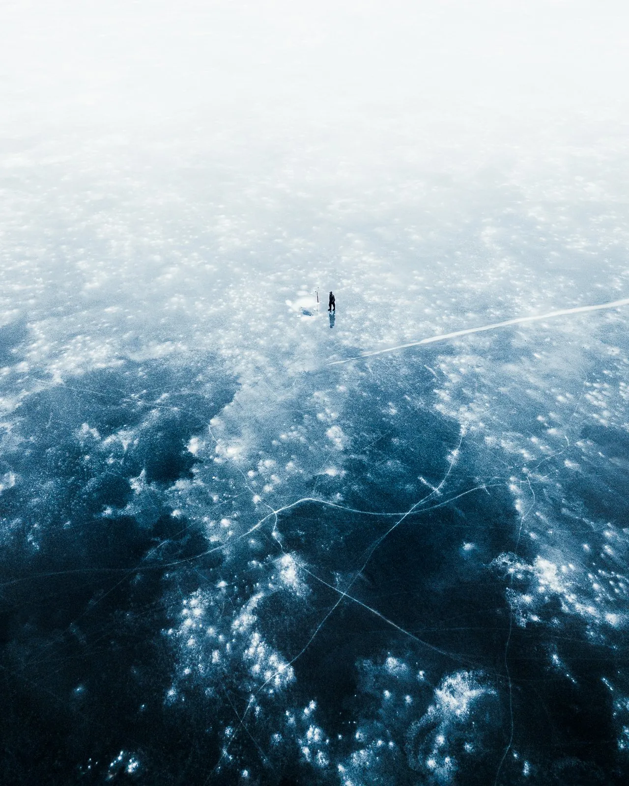 Frozen Lake, a landscape photograph centered on solitude from the Alone collection by Mikko Lagerstedt.