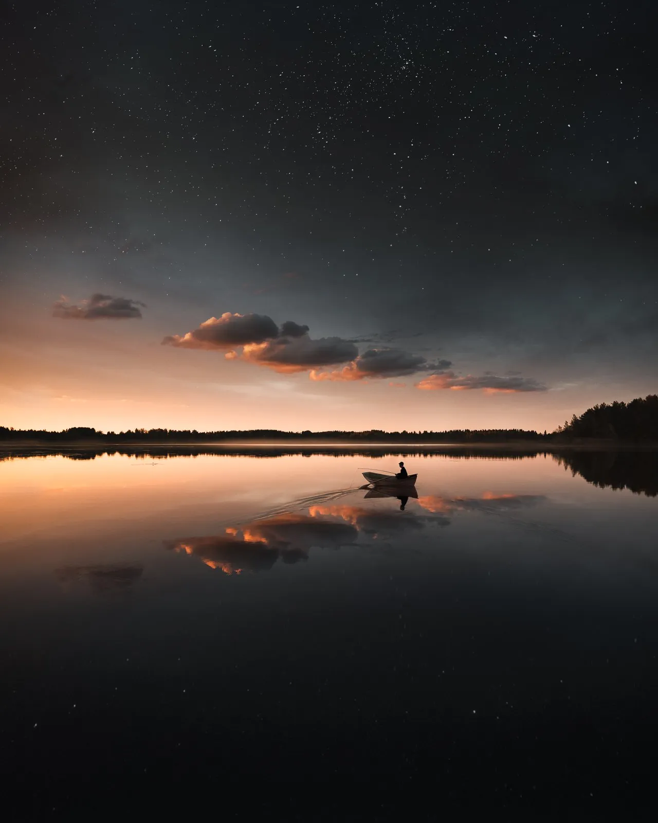Small boat floating on a calm lake at dusk from the Dream collection by Mikko Lagerstedt