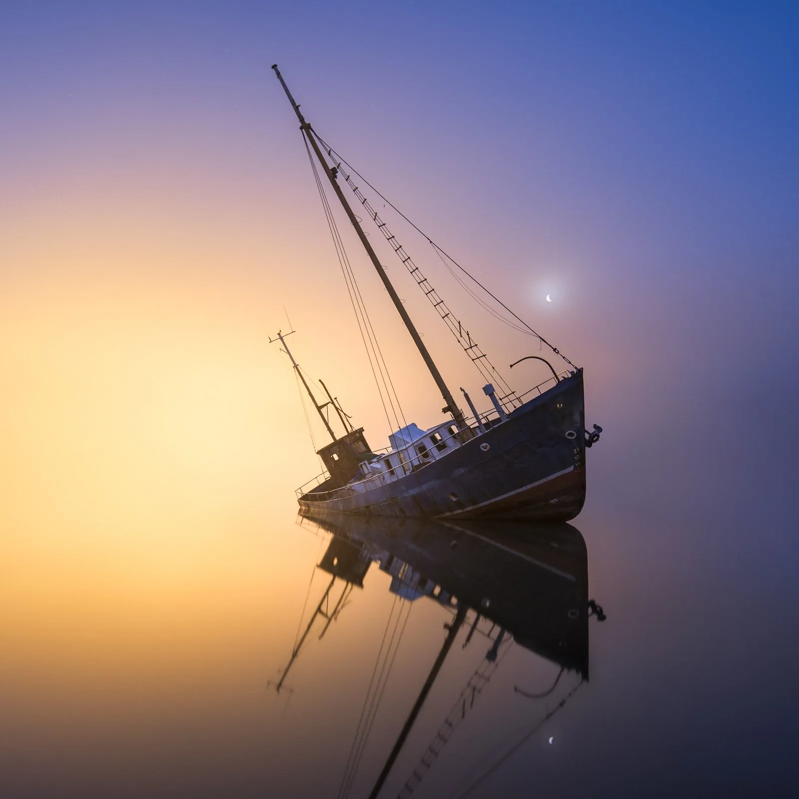 Soft evening mist and last light over still dark water