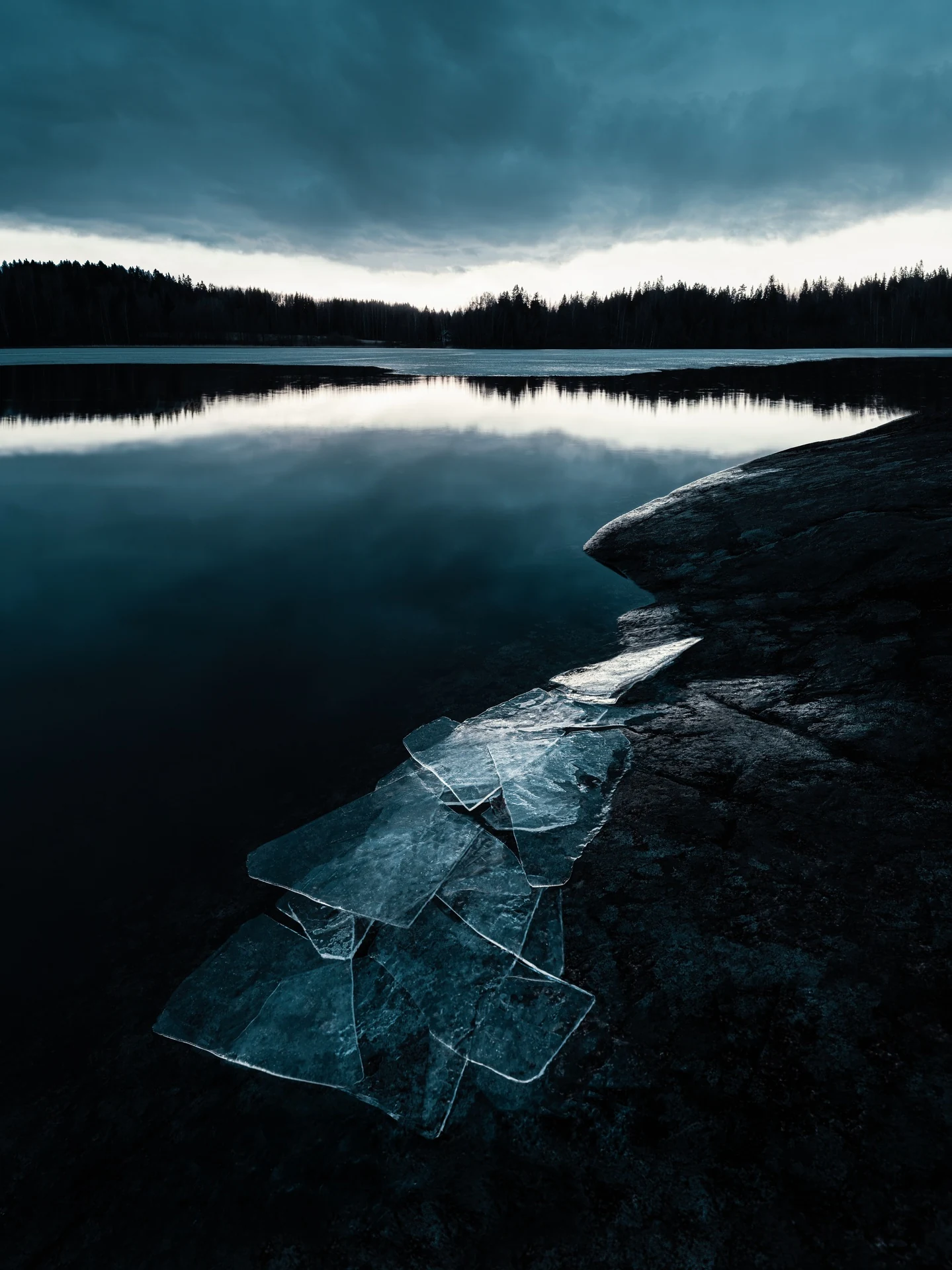 Winter shoreline at the edge between ice and open water